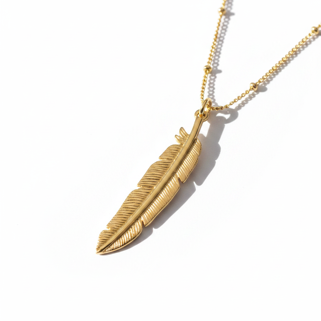 Gold Feather Pendant Necklace – White Background Editorial
