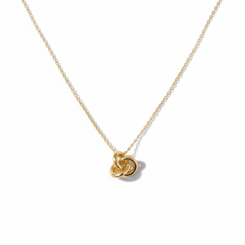 Gold Knot Necklace Flat Lay on White