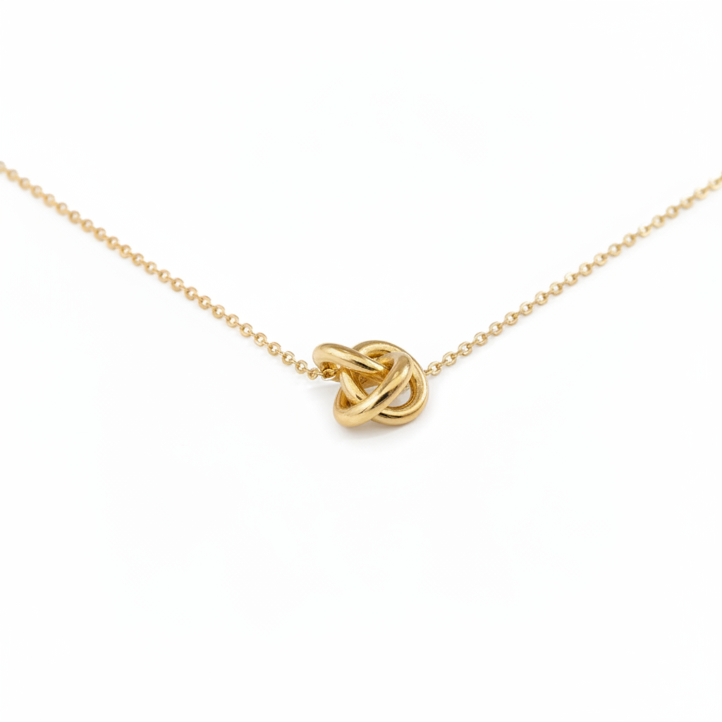 Gold Knot Necklace on White Background with Shadow