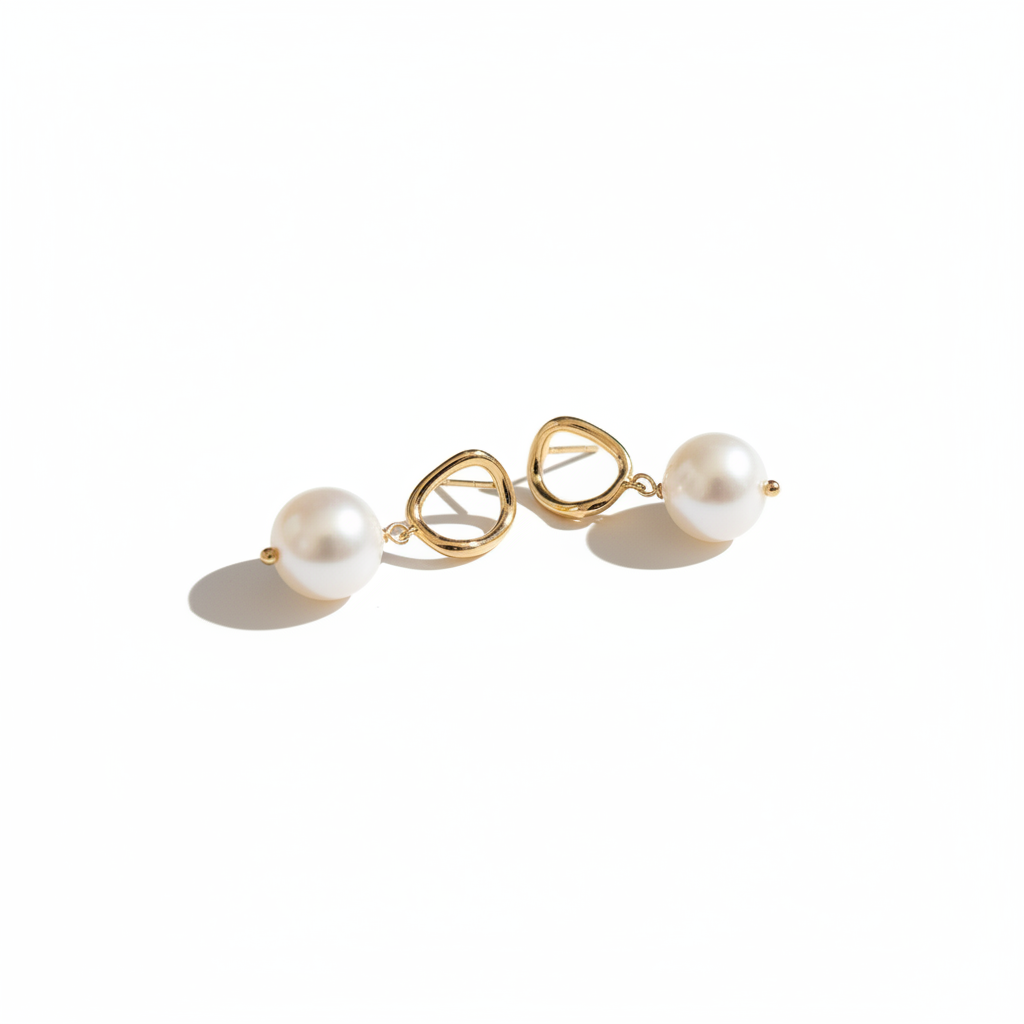 Gold Pearl Drop Earrings on White